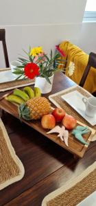 a wooden tray with fruits and vegetables on a table at Casa do Bairro - O seu refúgio in Ponta Delgada