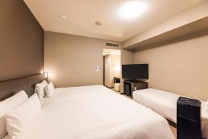 Postel nebo postele na pokoji v ubytování Hotel Sunroute Plaza Shinjuku