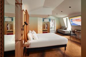 a bedroom with a bed and a living room at YOU Are Deauville in Deauville