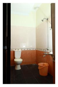 a bathroom with a toilet and a sink at RAMYA REGENCY in kāraikāl