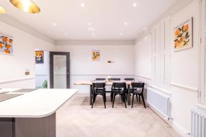 a dining room with a table and chairs at The Stanley in Teddington +35 photos