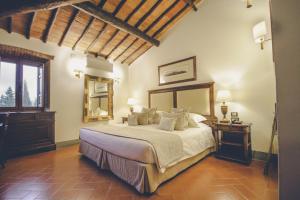 A bed or beds in a room at Capannelle Wine Resort