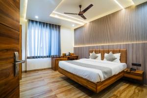 a bedroom with a bed and a ceiling fan at Hotel De Grand Dwarka-Near Jaipur Airport in Jaipur