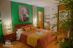 a bedroom with a bed with a green wall at A Casa dos Sonhos in Chaves +126 photos