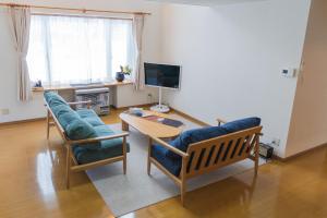 a living room with two chairs and a table at meet in Asahikawa