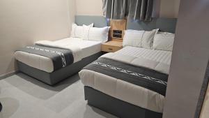 two beds in a small room withskirts at The Aeran Foods & Hospitality in Chhala