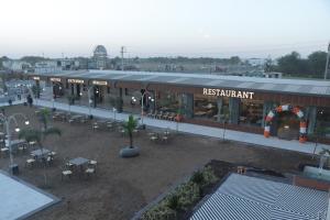 a train station with a restaurant with tables and chairs at The Aeran Foods & Hospitality in Chhala