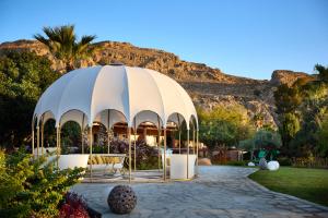 a domed building with a mountain in the background at Palazzo Navarone in Lindos