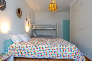 a bedroom with a bed with polka dot sheets at CASA DO TANQUE AMARELO by Stay in Alentejo in Vila Nova de Milfontes