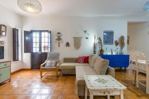 a living room with a couch and a table at CASA DO TANQUE AMARELO by Stay in Alentejo in Vila Nova de Milfontes