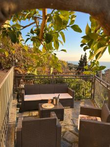 a patio with a couch and chairs and a table at Gassa d'Amante in Montaretto