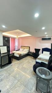 a room with two beds and a table and a piano at Sevil new apart in Istanbul