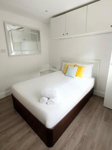 a bedroom with a large white bed with towels on it at Stylish City Centre Studio - Grand Central House in Gibraltar
