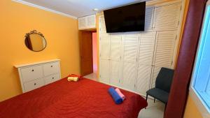 a bedroom with a bed and a flat screen tv at App 308 - Wundervoller Meerblick, sehr zentrale Lage, angenehm ruhig in Tías