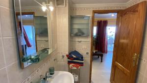 a bathroom with a sink and a mirror at App 308 - Wundervoller Meerblick, sehr zentrale Lage, angenehm ruhig in Tías +15 photos