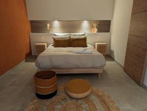 a bedroom with a bed and two baskets on the floor at Le Rituel in Fréchencourt