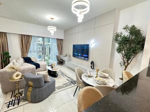 a living room with a couch and a table at Central Park Towers Royal suite DIFC Downtown in Dubai
