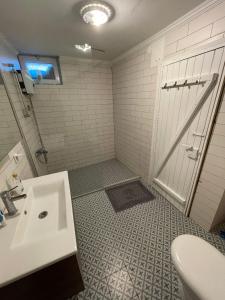 a bathroom with a white sink and a shower at Cozy Stone house in the Bozcaada center in Bozcaada