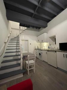 a kitchen with a staircase leading to a kitchenasteryasteryasteryasteryasteryasteryastery at Cozy Stone house in the Bozcaada center in Bozcaada