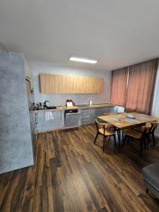 a kitchen with a table and chairs in a room at Apartman Velka Lomnica Lesna 5 in Veľká Lomnica +9 photos
