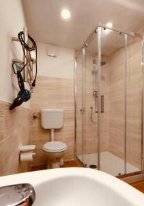 a bathroom with a shower and a toilet and a tub at Norman City House in Palermo