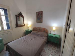 a small bedroom with a bed and two night stands at Maison jaune médina de Tunis in Tunis