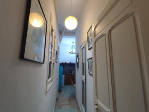 a hallway with two lights on the wall and a hallway with a hallway at Maison jaune médina de Tunis in Tunis