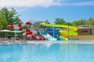 a water park with a water slide in a pool at Camping Bijela Uvala - Roan in Poreč