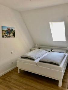 a white bed in a room with avertisement at 'Lieblingsbude' in Langeoog