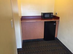 a microwave sitting on top of a counter in a room at Howard Johnson by Wyndham San Diego Sea World in San Diego