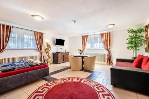 a large living room with two beds and a tv at Villa Waldpark in Dresden