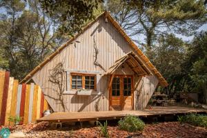 a small wooden house with a wooden deck at Sortilège in Lambesc +10 photos