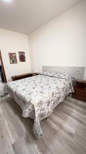 a bedroom with a bed with a comforter on it at Casa Vacanze Nuvola in Pietralunga