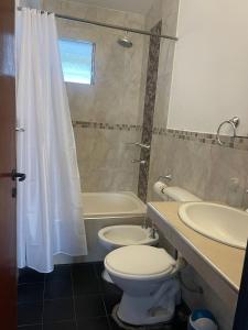 a bathroom with a toilet and a sink and a shower at casa San Isidro in Cafayate