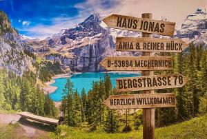 a sign with distances to mountains and a lake at Haus Jonas in Mechernich
