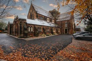 an old church with cars parked in front of it at Rare Historic Church Stained Glass Parking in Waterloo