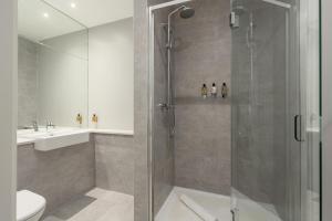 a bathroom with a shower and a toilet and a sink at Destiny Scotland Apartments at Canning Street Lane in Edinburgh +46 photos