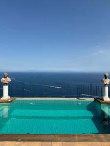 a swimming pool with the ocean in the background at Residenza San Luca Praiano in Praiano