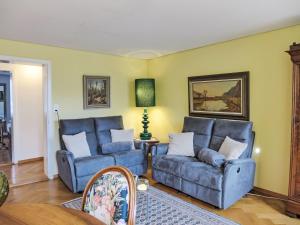 a living room with two blue couches and a table at Apartment Bieri-Haus by Interhome in Unterseen