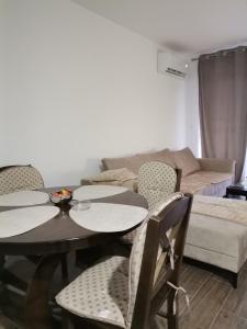 a living room with two tables and a couch at Apartman Janković in Veliko Gradište +11 photos