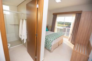 Cama ou camas em um quarto em Ilhas do Lago Eco Resort by WAM Experience