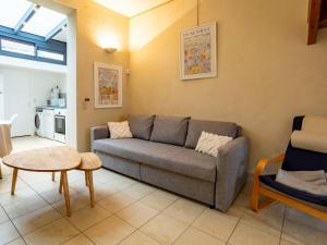 a living room with a couch and a table at Holiday Home Gambetta by Interhome in Deauville