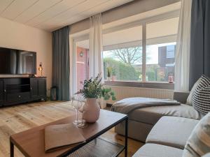 a living room with a couch and a table at FeWo Nordstern - Schillig in Wangerland