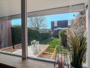 a sliding glass window of a patio with a table at FeWo Nordstern - Schillig in Wangerland