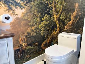 a bathroom with a wall mural of a forest at Pennington Grove in Gatesville