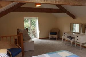 a bedroom with a bed and a dresser and a window at 1 bed-cottage-Parking-Patio-close to coasts in North Hill