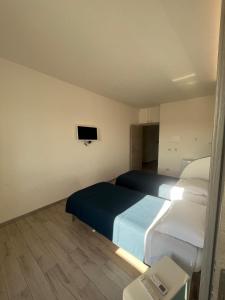 Postel nebo postele na pokoji v ubytování piazza Marconi Rooms