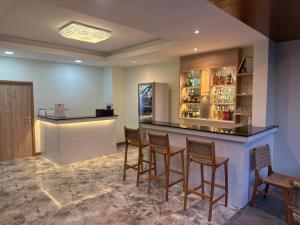 a bar with chairs and a counter in a room at Sumaka Hotel Karon in Kata Beach