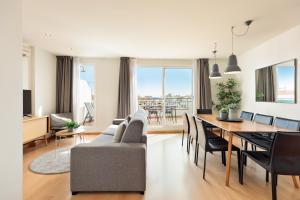 a living room with a couch and a dining room table at Sitges Group Soul in Sitges