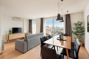 a living room with a dining table and a couch at Sitges Group Soul in Sitges